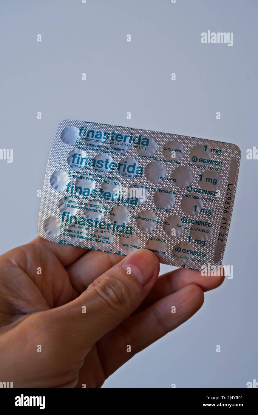 RIO DE JANEIRO, BRAZIL - APRIL 30, 2021: Blister pack of finasteride pills on hand Stock Photo
