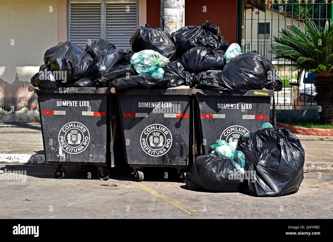 RIO DE JANEIRO, BRAZIL - NOVEMBER 14, 20121: Black dumpsters and trash bags in residential condominium at Itanhanga neighborhood Stock Photo