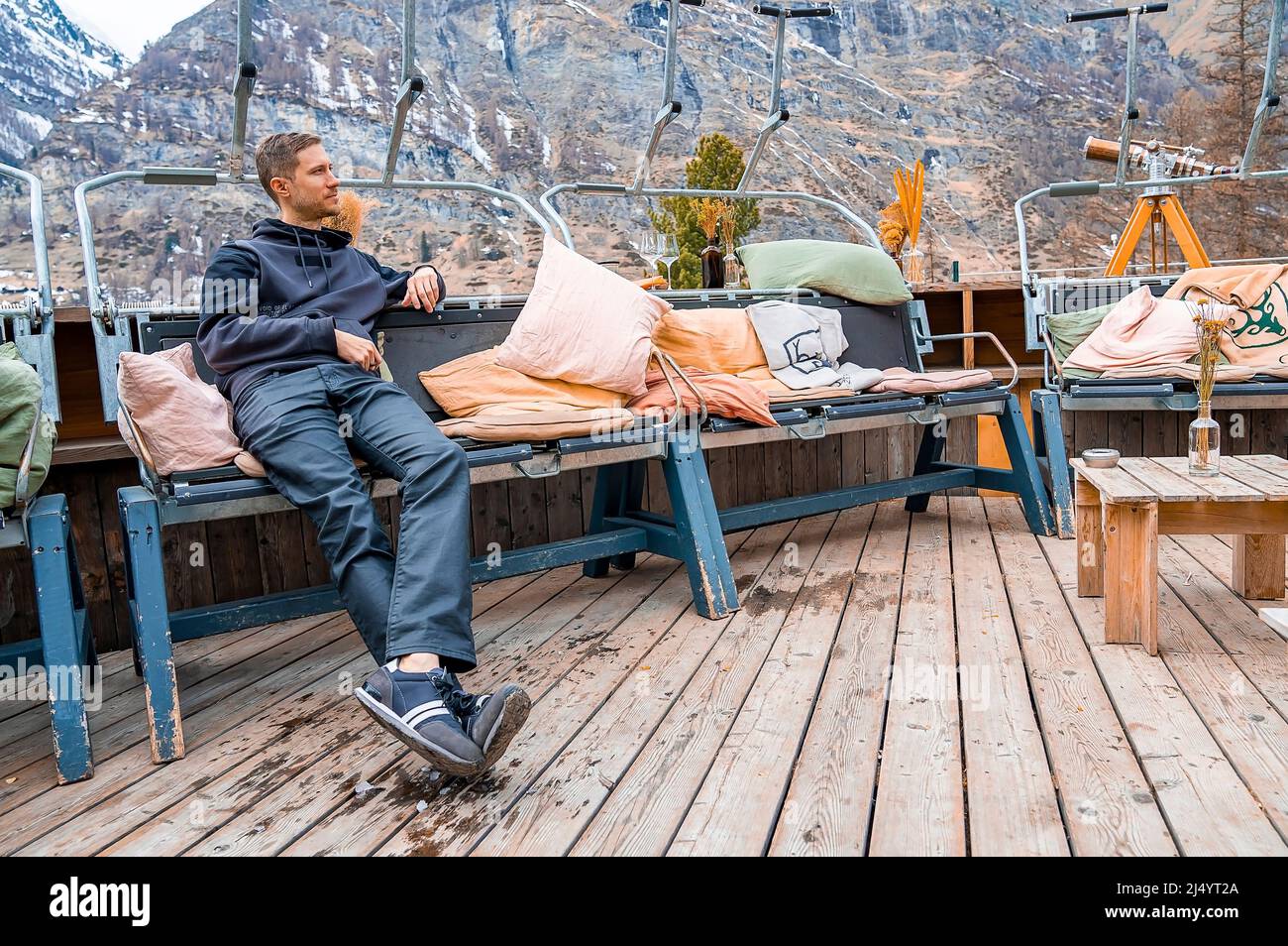 Man Rest Thoughtful man resting at outdoor sitting area in resort against ...
