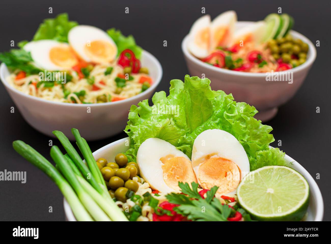 Beautiful Noodle Dish with Green Onions, Eggs, Green Pea, Red Hot Pepper, Greens and Lime on