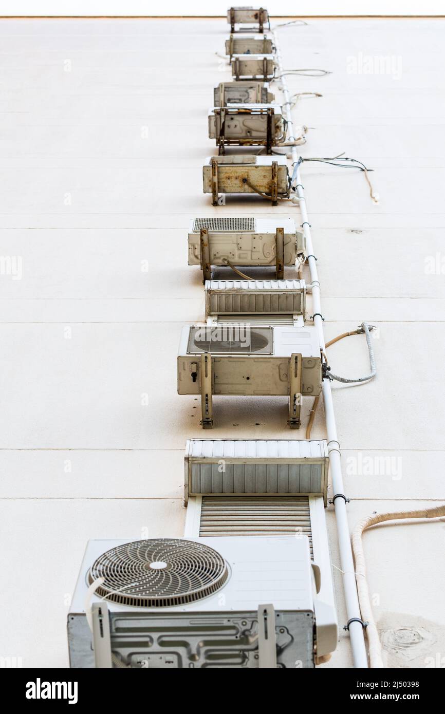 Split air conditioner outdoor unit hung outside the building Stock Photo Alamy