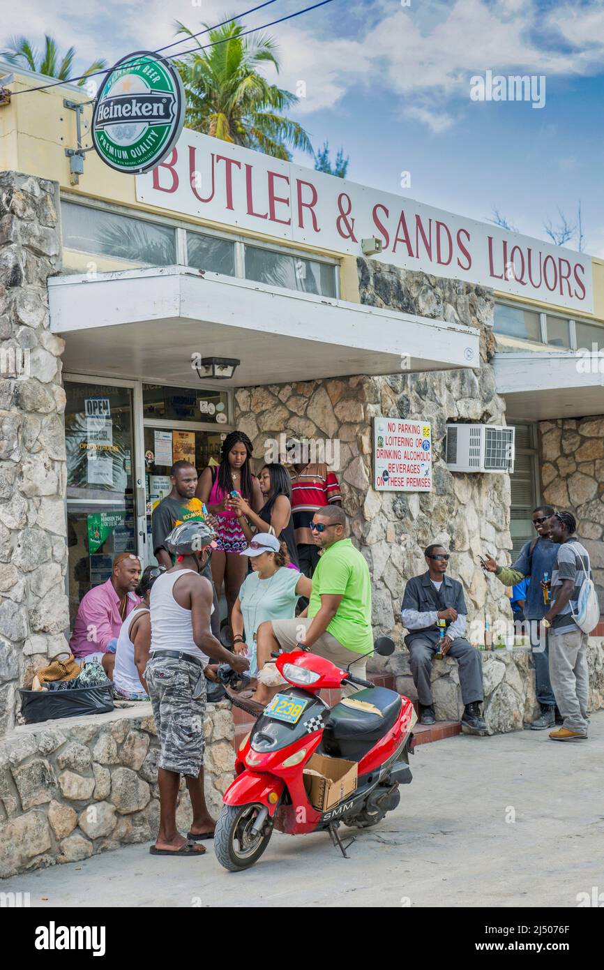 A payday crowd gathers outside a store in Bimini, the Bahamas. Stock Photo