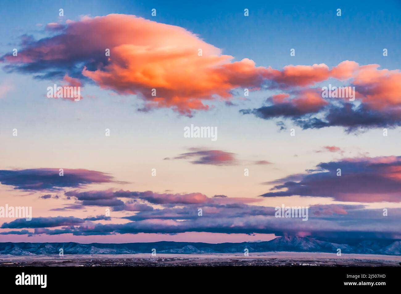 Sunset clouds float above the Sandia–Manzano Mountains on Route 66 outside Albuquerque, New Mexico. Stock Photo