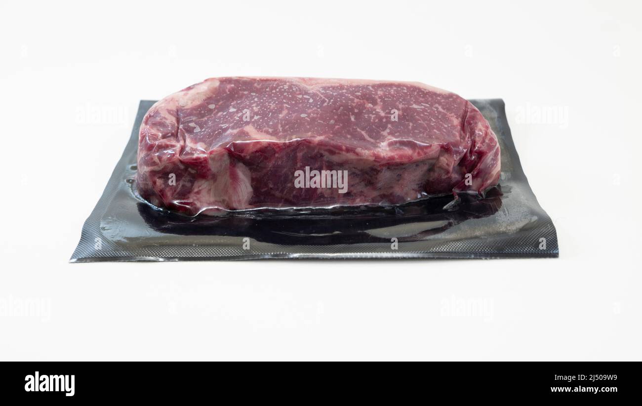 raw piece of beef for steak in vacuum packaging isolated on white