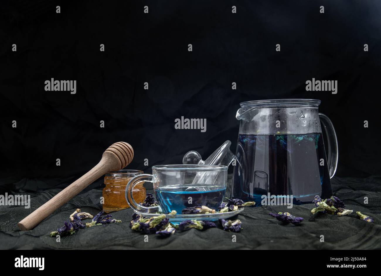 Butterfly pea tea (Clitoria) or Organic blue anchan in Teapot and glass ...