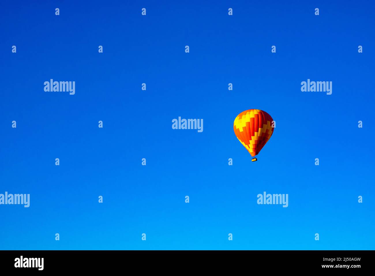 Hot Air Balloon. Single red and yellow colored hot air balloon isolated