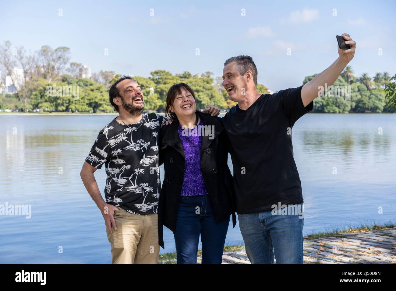 Group of friends of different ages taking a selfie in a lake. Happy expressions. Copy space Stock Photo