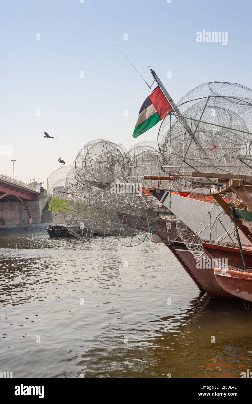 Traditional fishing dhows laden with gargours, or fish traps, near Sharjah Bridge in Sharjah in the United Arab Emirates. Stock Photo
