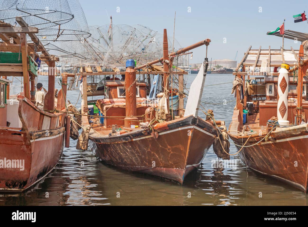 Traditional fishing dhows laden with gargours, or fish traps, near Sharjah Bridge in Sharjah in the United Arab Emirates. Stock Photo