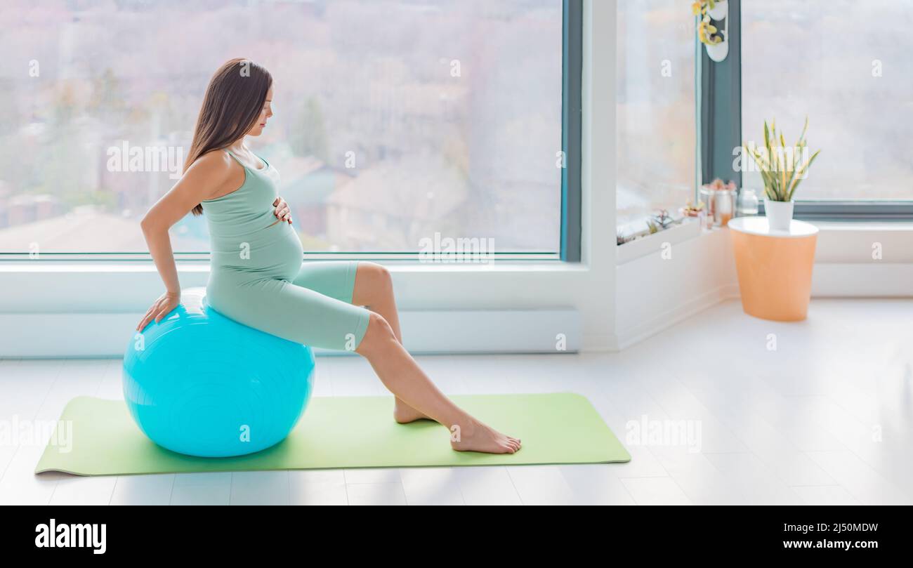 Pregnant woman stability ball prenatal pregnancy home workout stretching muscles for birth using