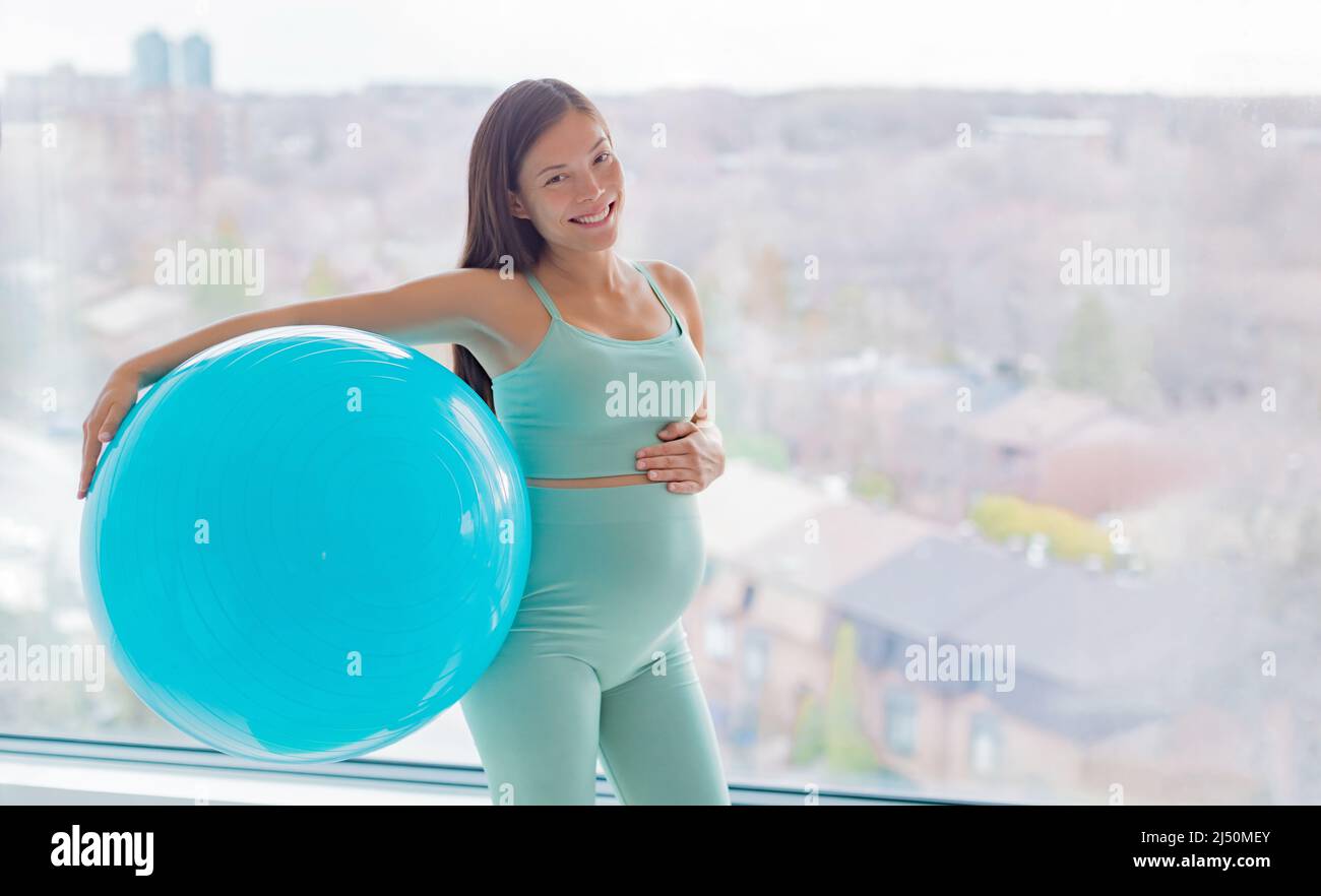 Pregnancy workout. Asian pregnant woman training with stability ball