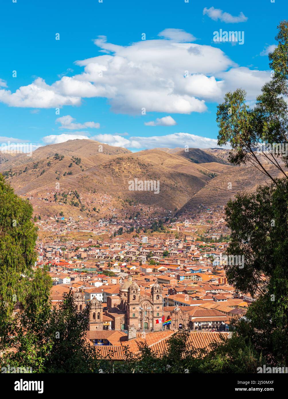 Vertical aerial city skyline of ancient inca capital Cusco with Compania de Jesus church and Plaza de Armas square, Cusco province, Peru. Stock Photo