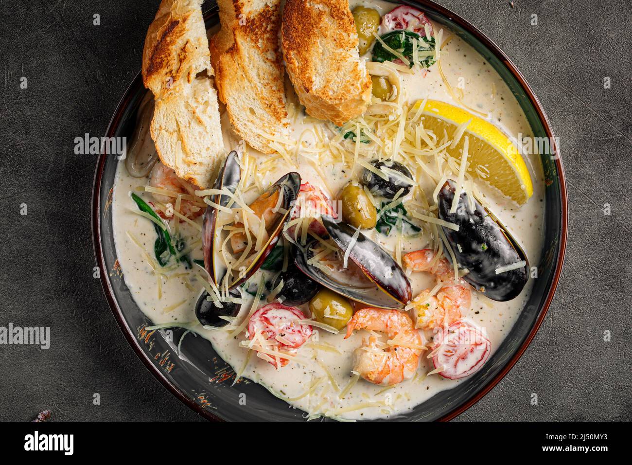 Portion of seafood saute with wheat bread Stock Photo