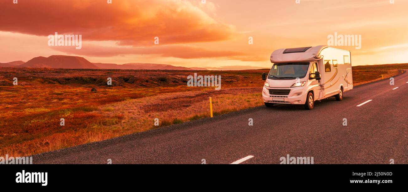 Motorhome camper van RV road trip. People on travel vacation adventure. Tourists in rental car campervan by view of mountains in beautiful nature Stock Photo