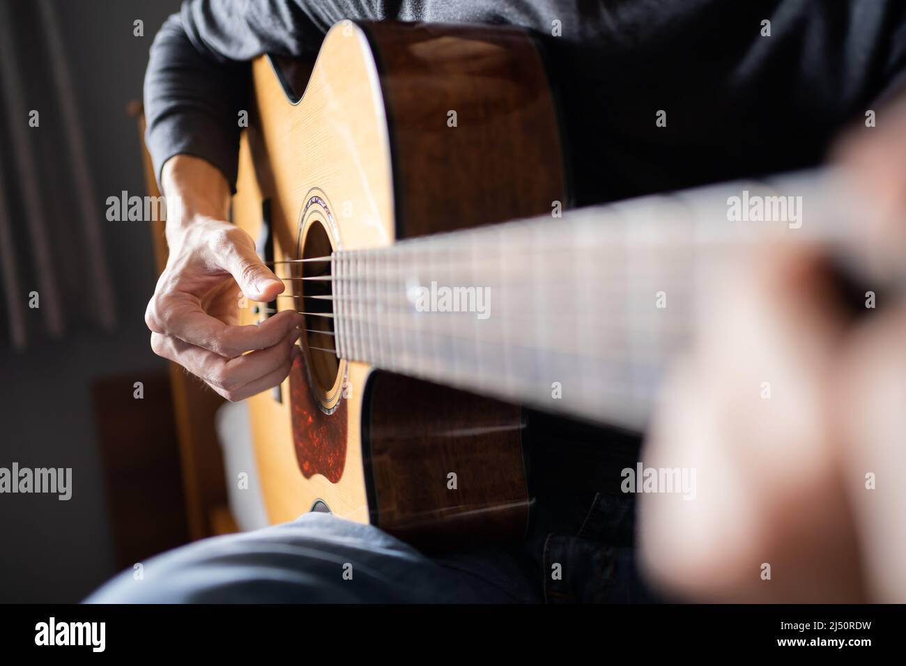 Acoustic guitar played by a man Stock Photo