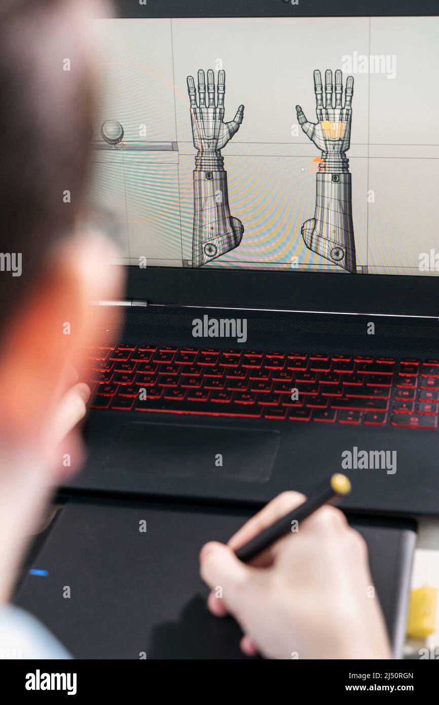 digital artist working on 3d graphics using a graphics tablet. Stock Photo