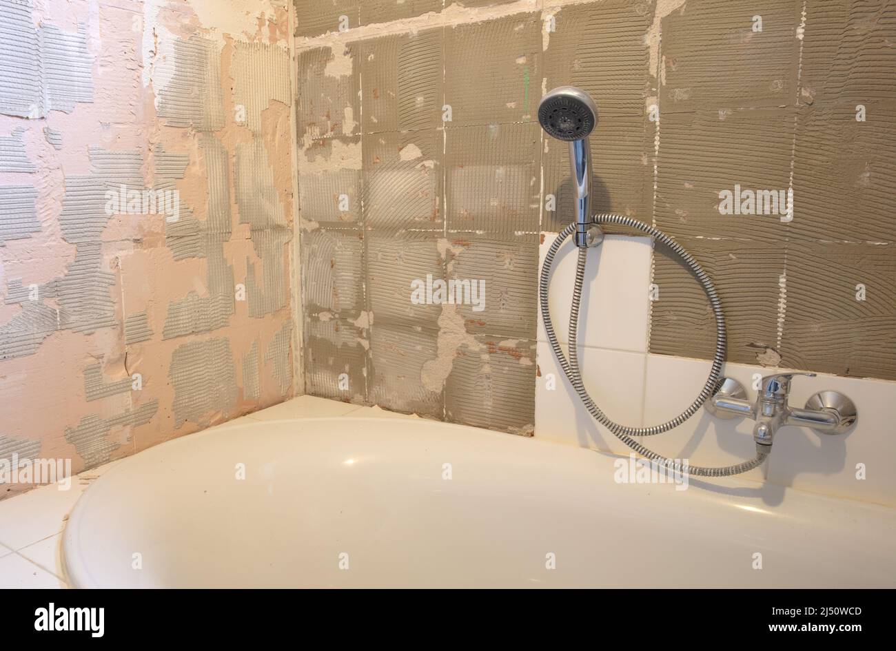 Preparation or repair of the bathroom, removing old tiles Stock Photo