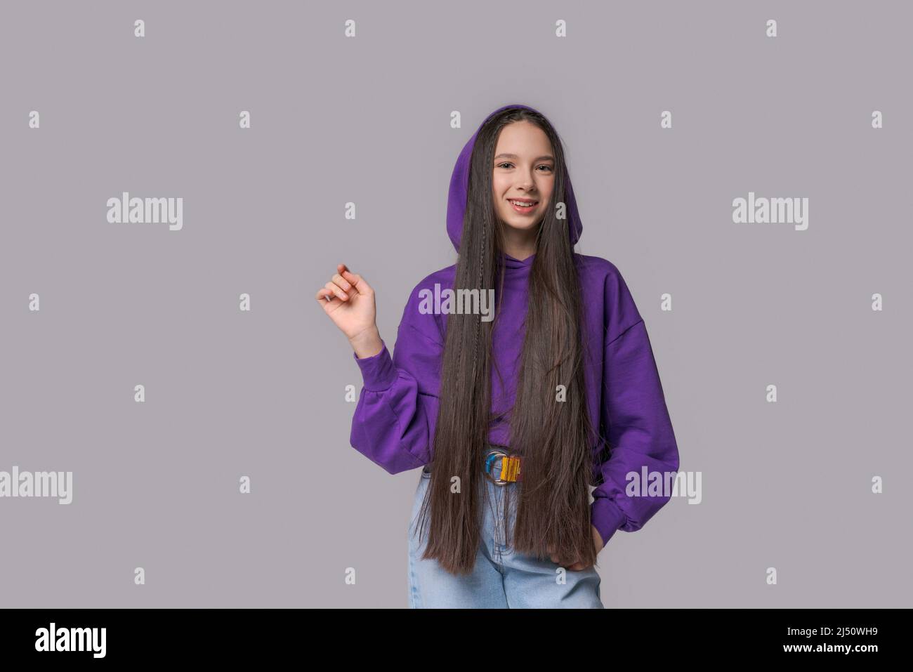 Portrait cute lovely cute sweet attractive charming cheerful cheerful girl wearing lilac swingshot gesturing isolated on pastel gray background Stock Photo