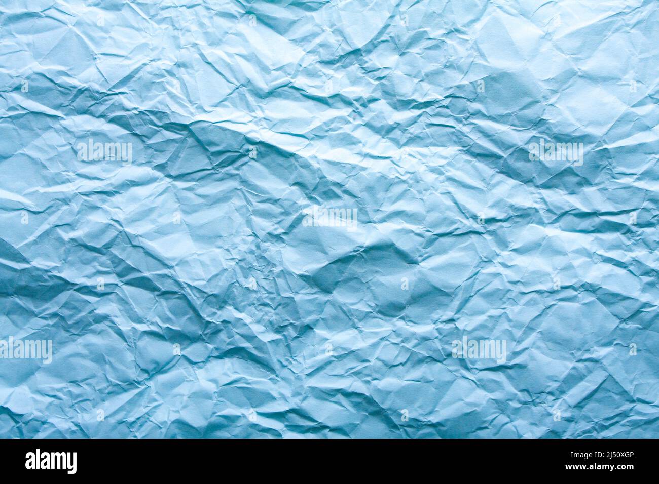 Blue wrinkled paper background with abstract seamless pattern. Crumpled  paper texture Stock Photo - Alamy