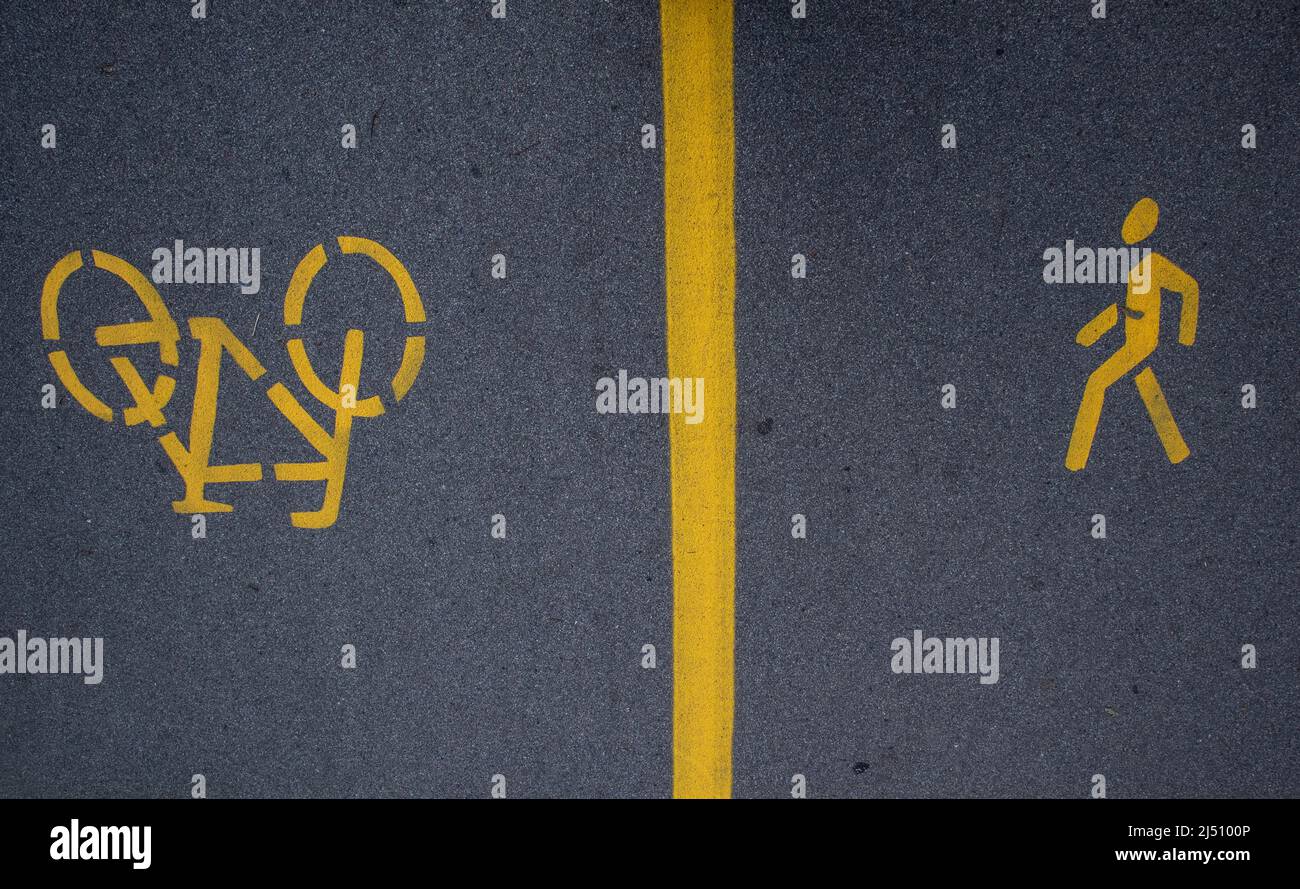 yellow road markings on asphalt, separate path for pedestrians and bicycles Stock Photo Alamy