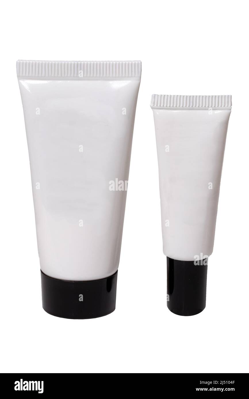 Containers for beauty products. Closeup of two white cosmetic tubes of different sizes with