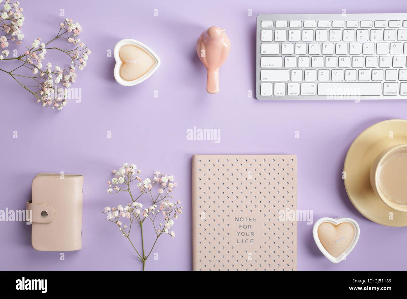 Cozy home office desk table with keyboard, notebook, coffee cup, accessories  and gypsophila flowers on pastel purple background. Elegant feminine work  Stock Photo - Alamy