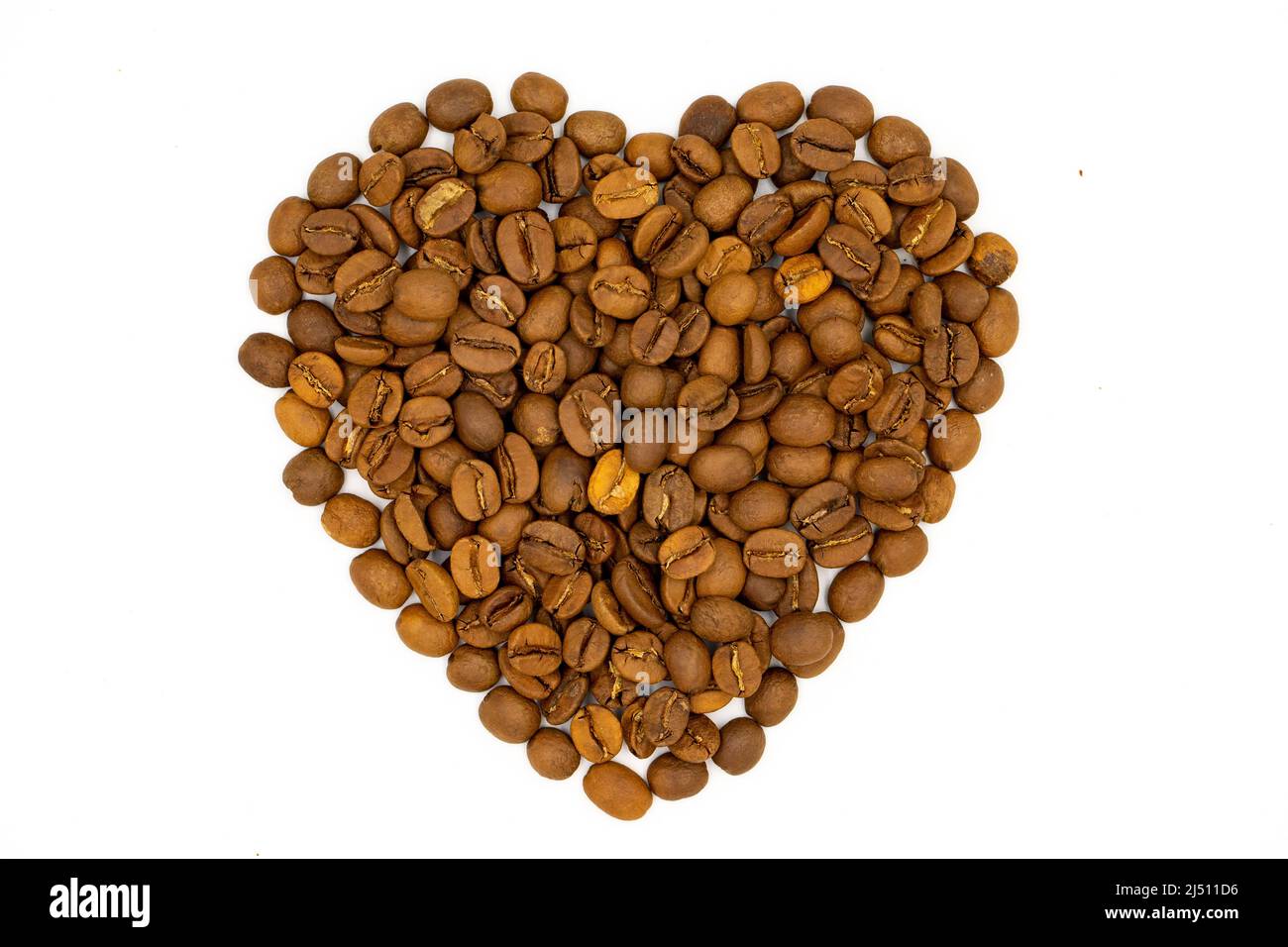 Coffee beans isolated on a white background. Heart shape with coffee beans. Close-up. Top view Stock Photo