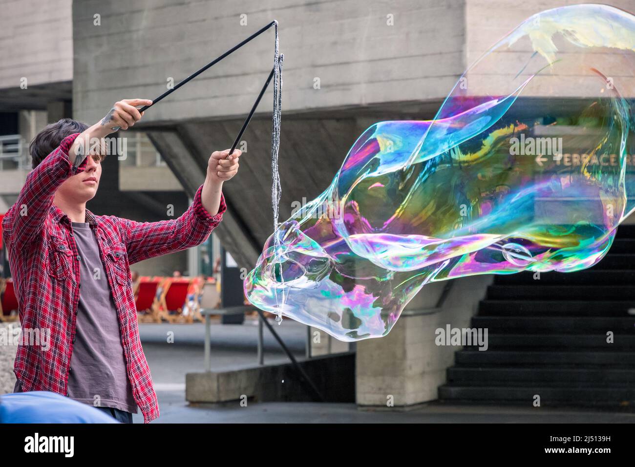 London, UK - July 19, 2021 - A soap bubble street performer around South Bank area Stock Photo