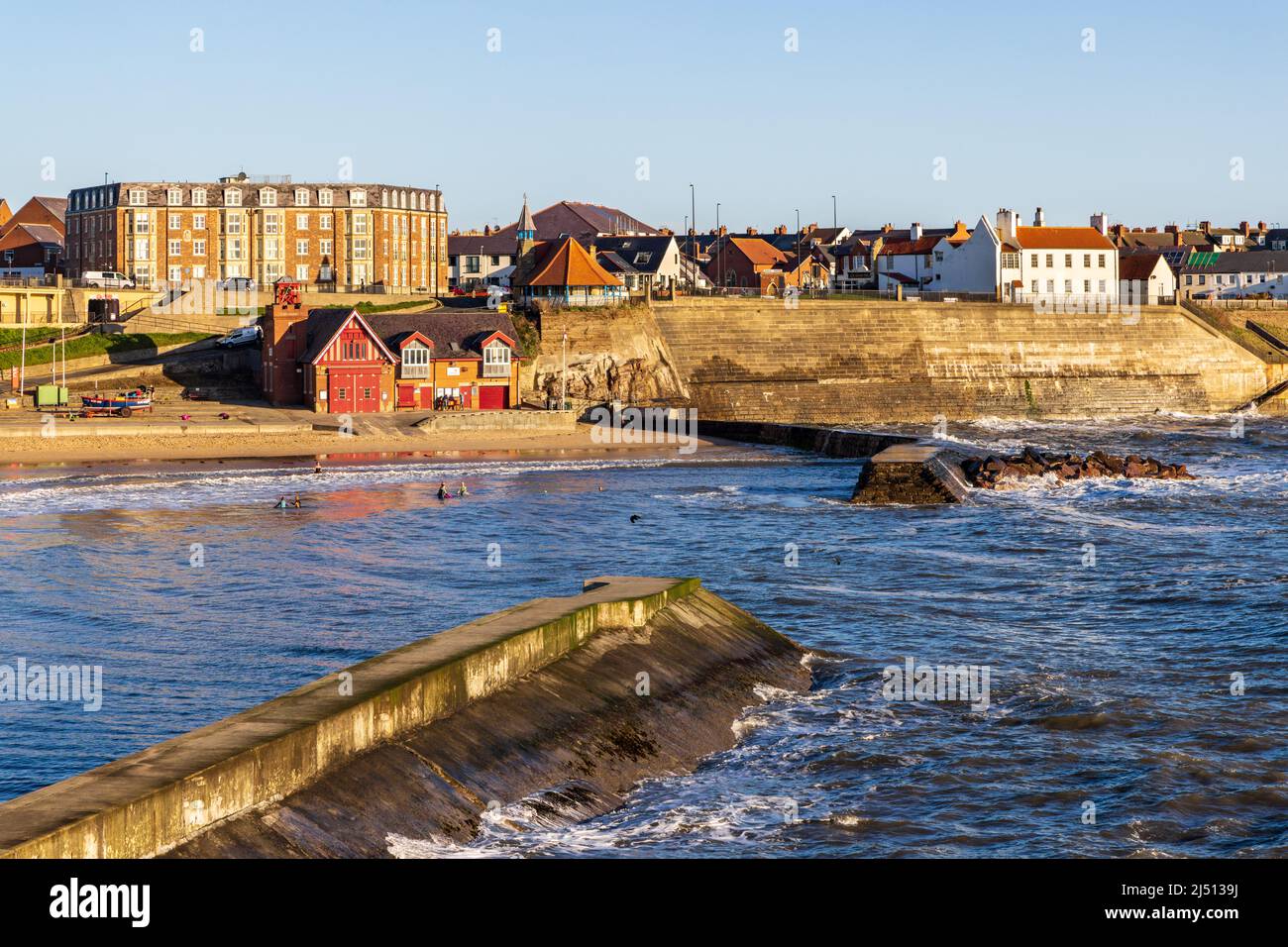 Early morning sun shines on Cullercoats and its harbour in North Tyneside. Stock Photo