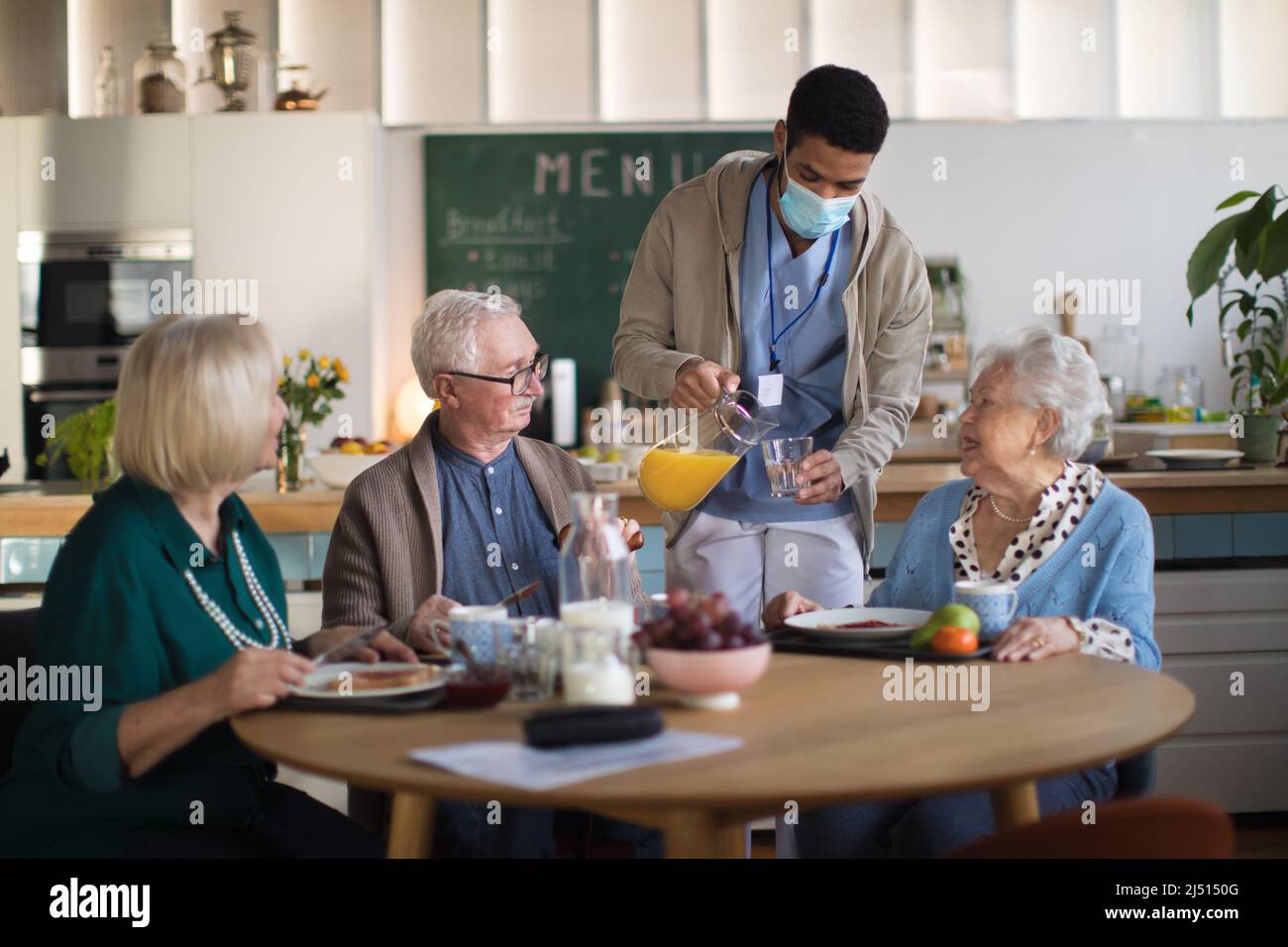 Group of cheerful seniors enjoying breakfast in nursing home care center Stock Photo Alamy