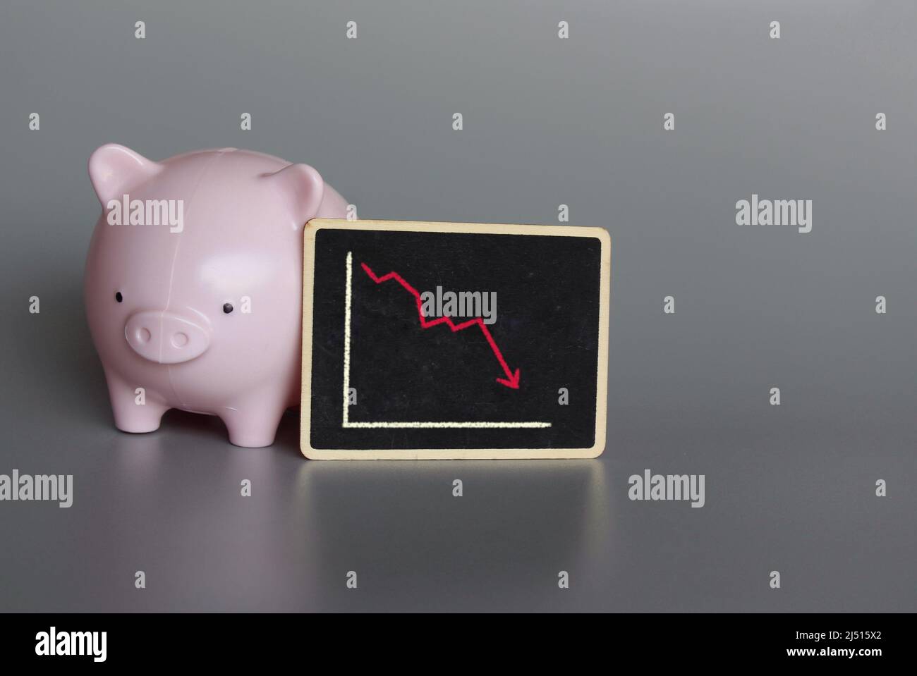 Piggy bank and graph chart. Economy crisis, expenditure of savings and ...