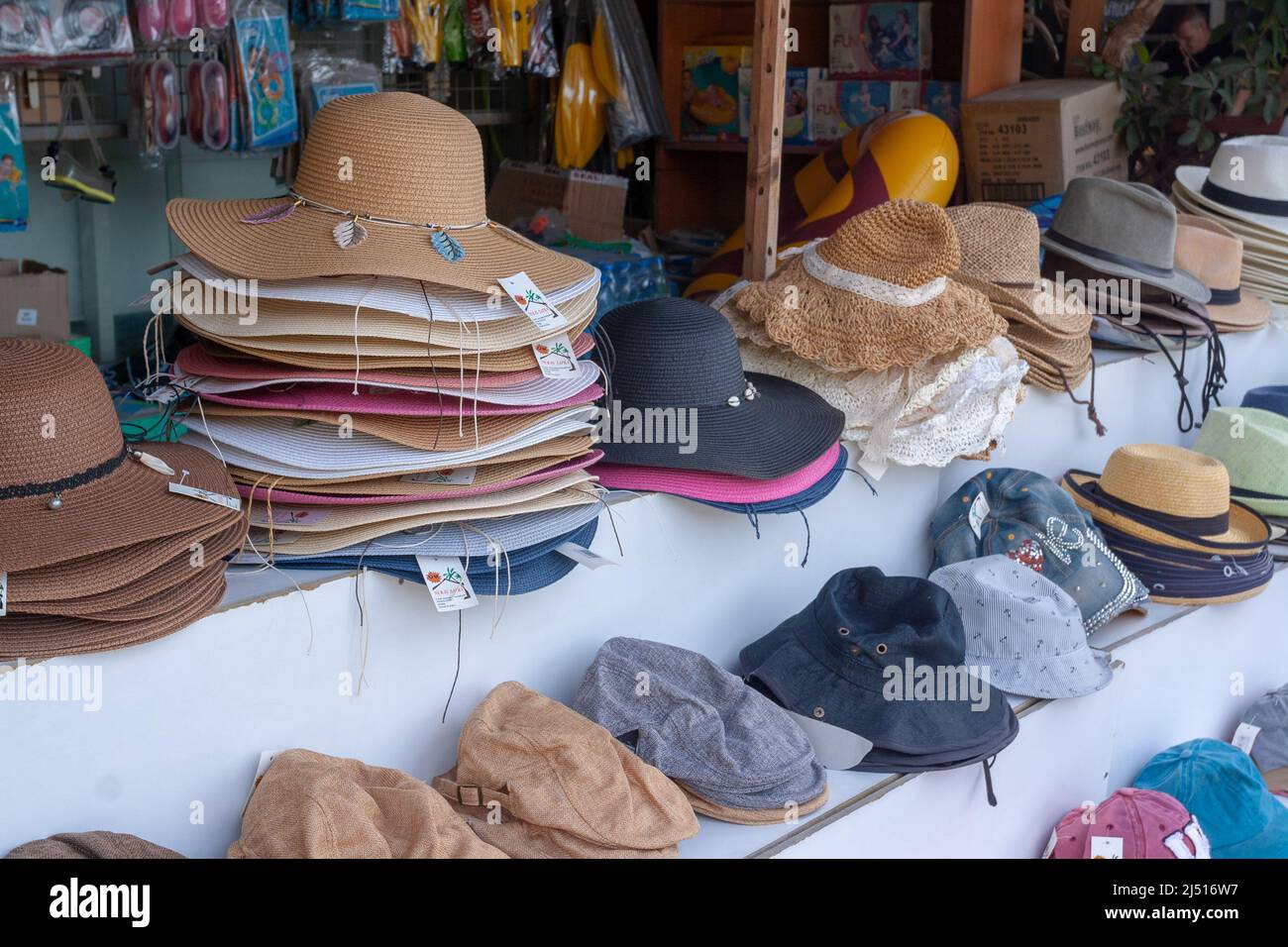 Street stall with different mens and womens hats and caps. Horizontal