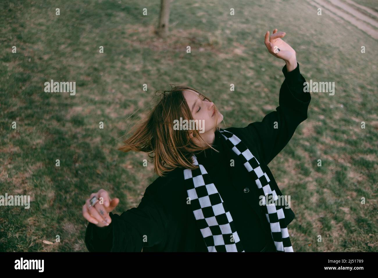 Scandinavian girl in gray casual modern clothes dancing a ritual dance ...