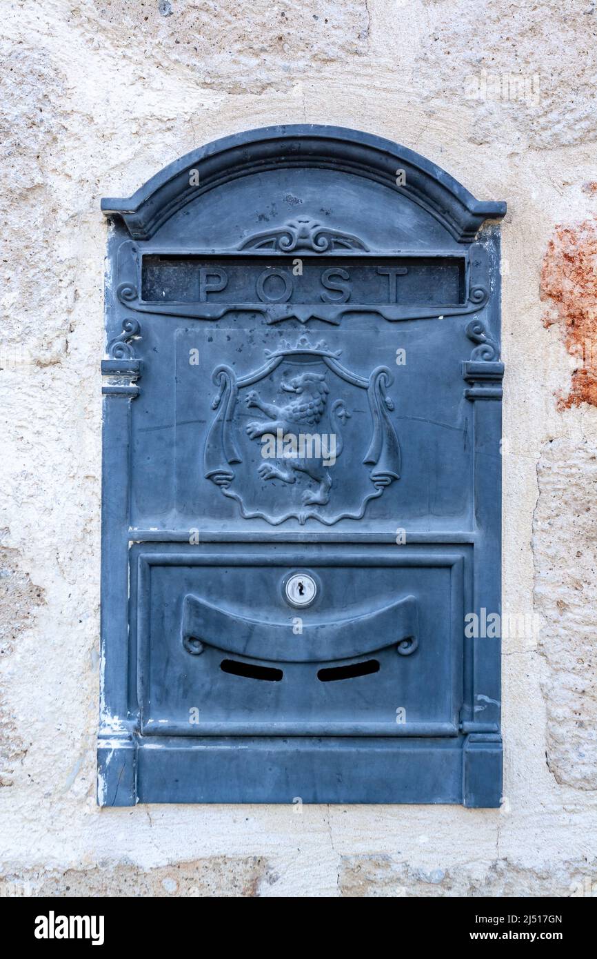 Old mailbox with lion on the coat of arms built into the wall. Vertical photo. Stock Photo