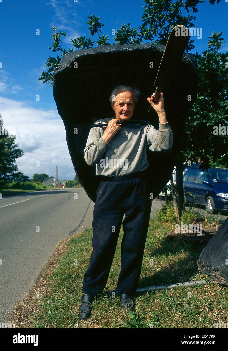 Bernard Thomas, Coracle Maker, LLechryd, near Cardigan, Wales. With a coracle he recently made. Stock Photo