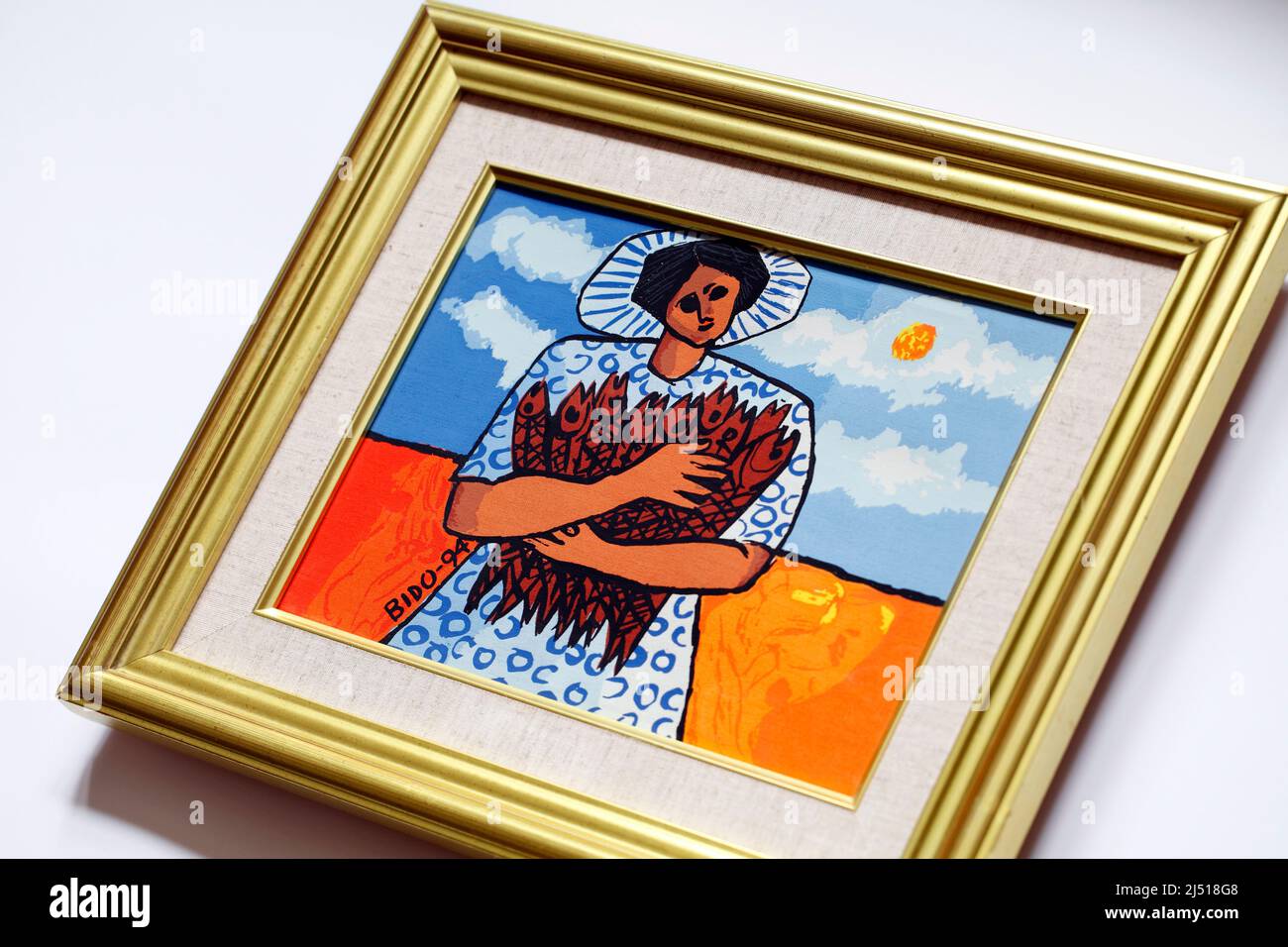 Canvas Screen print by Candido Bido, typical of his style with bright coloursa, the sun and a woman from the Dominican Republic, here  holding 9 fish Stock Photo