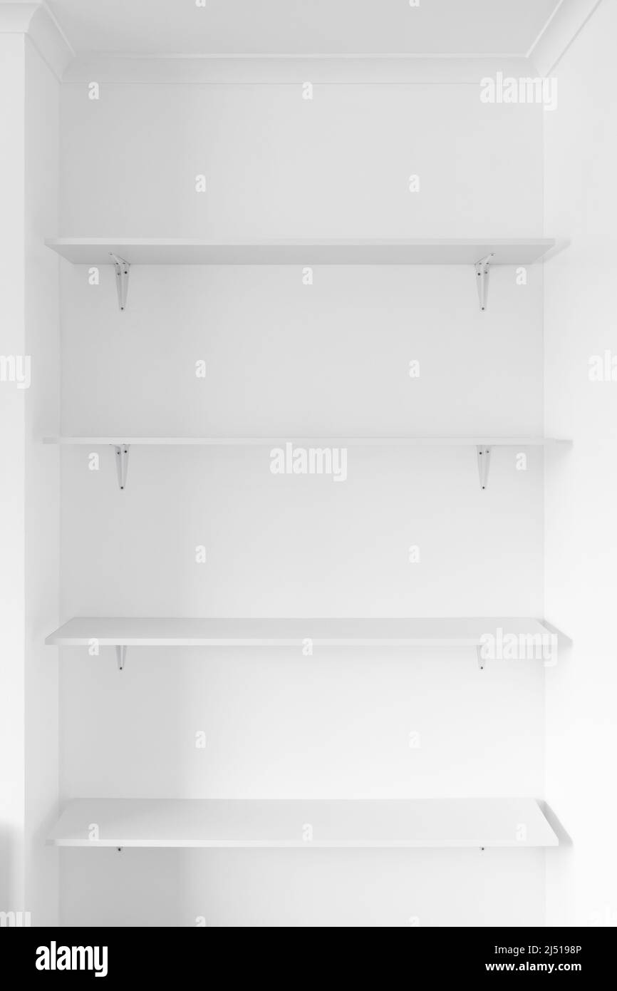 minimalist white wall with white shelves in a niche, concept of modern