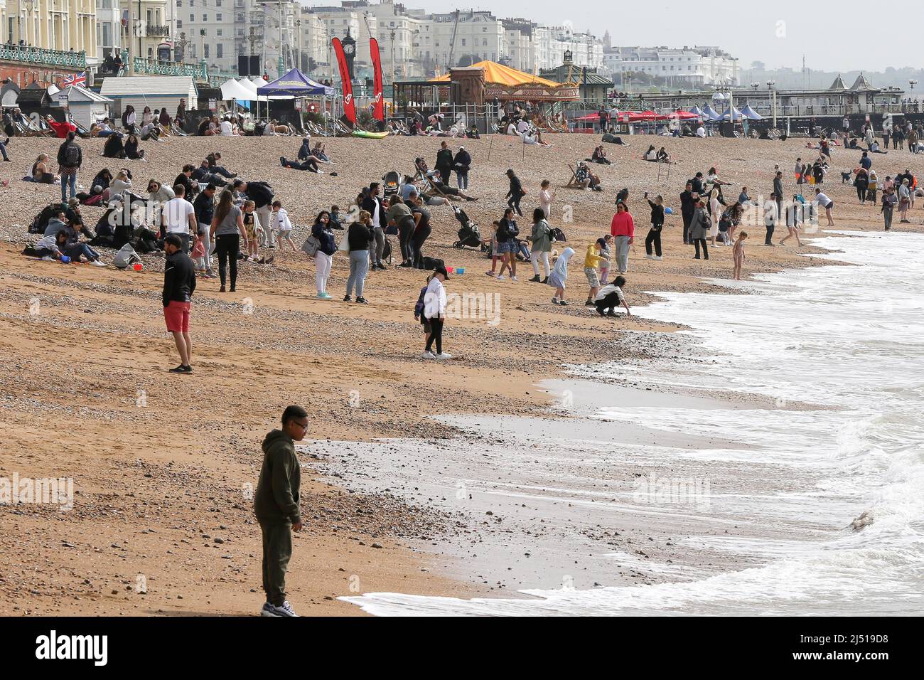 Brighton. UK 18 Apr 2022 - Sun-seekers enjoy Easter Monday on the Brighton seafront as the mini-heatwave is set to end with light showers and temperatures of around 13 degrees Celsius. Credit Dinendra Haria /Alamy Live News Stock Photo