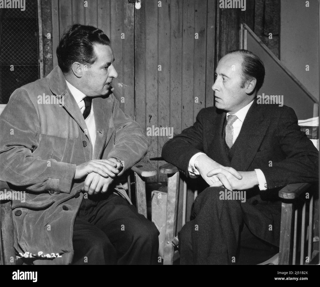 Writer TED WILLIS and Director ROY WARD BAKER on set candid during filming of FLAME IN THE STREETS 1961 director / producer ROY WARD BAKER story / play / screenplay Ted Willis Somerset Films / The Rank Organisation Stock Photo