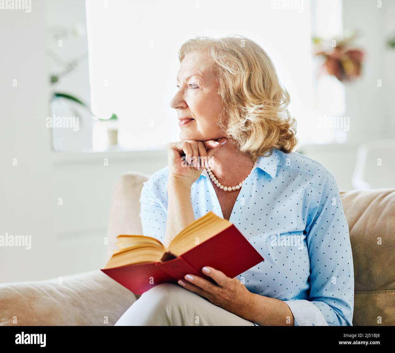 mature woman book portrait senior happy reading elderly lifestyle retirement indoor female smiling home relaxation alone lonely Stock Photo