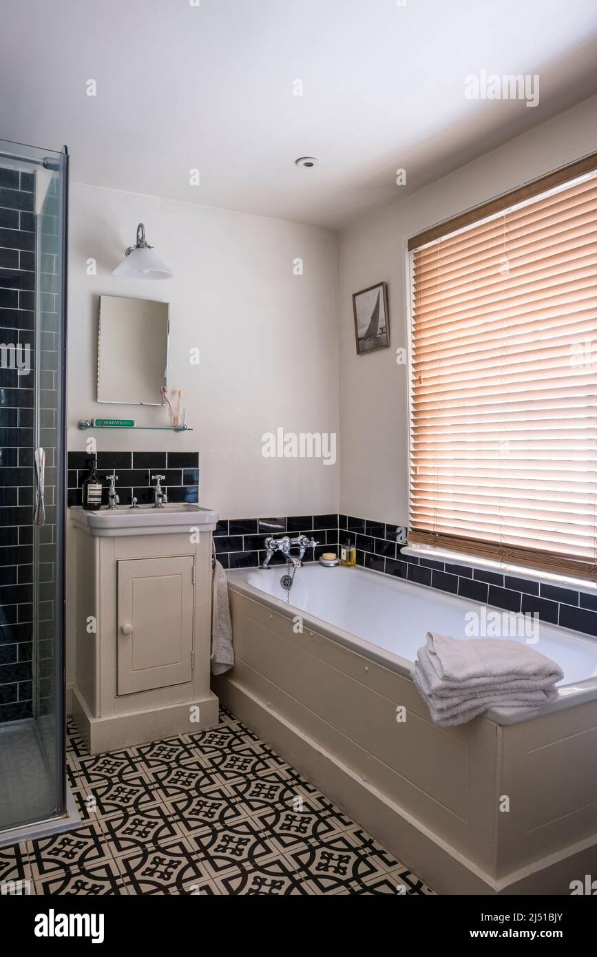 Abbey Woburn 19th century design floor tiles in bathroom of Grade II listed 1820s London cottage, UK Stock Photo