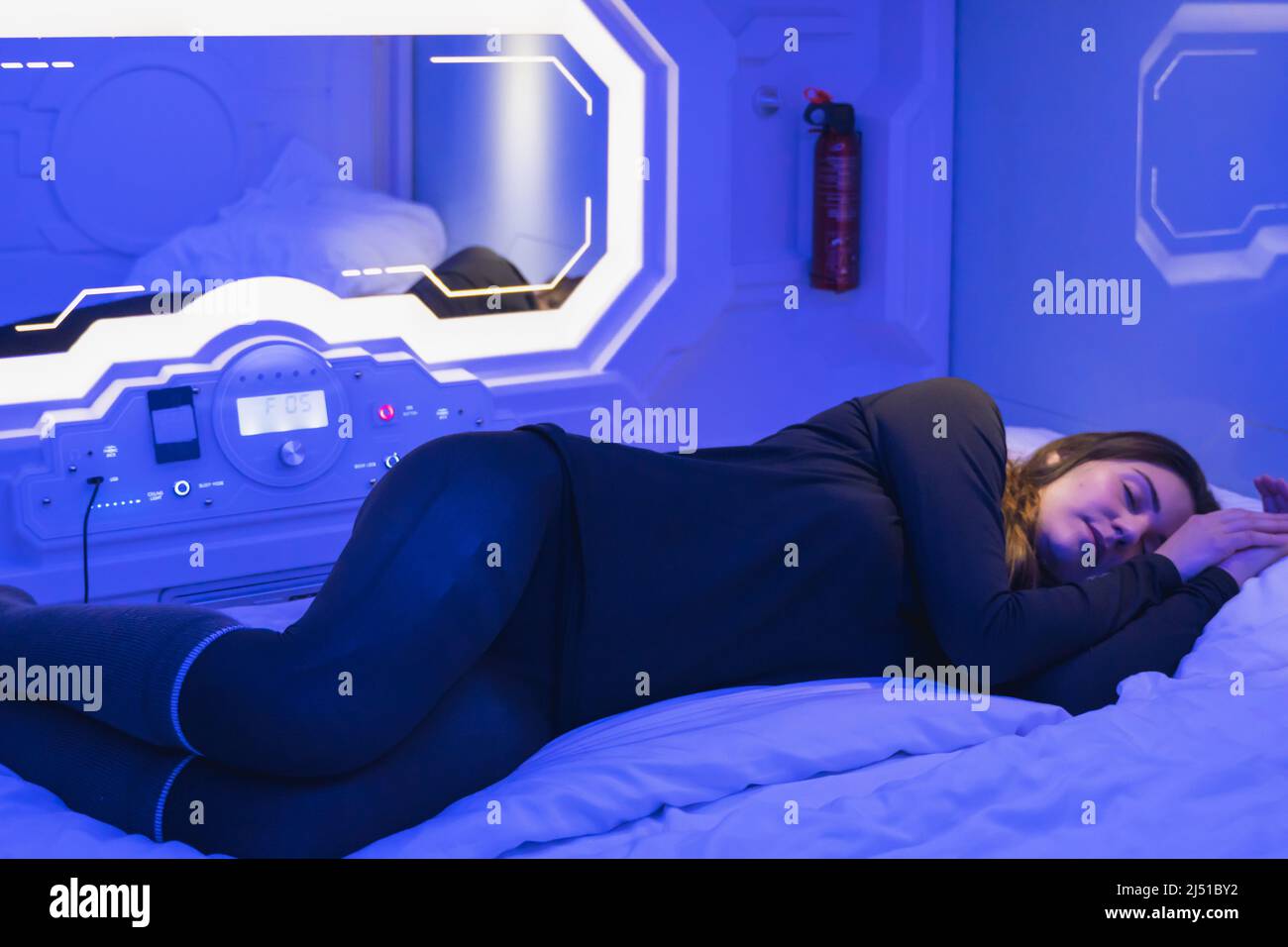 woman sleeping in the bedroom capsule. Stock Photo