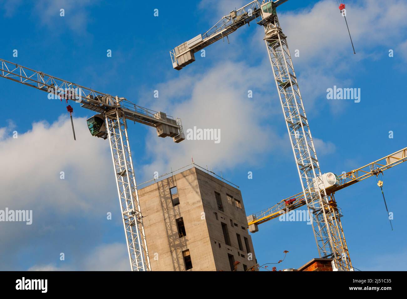 Cranes on a Construction or Building SIte with a blue sky Stock Photo