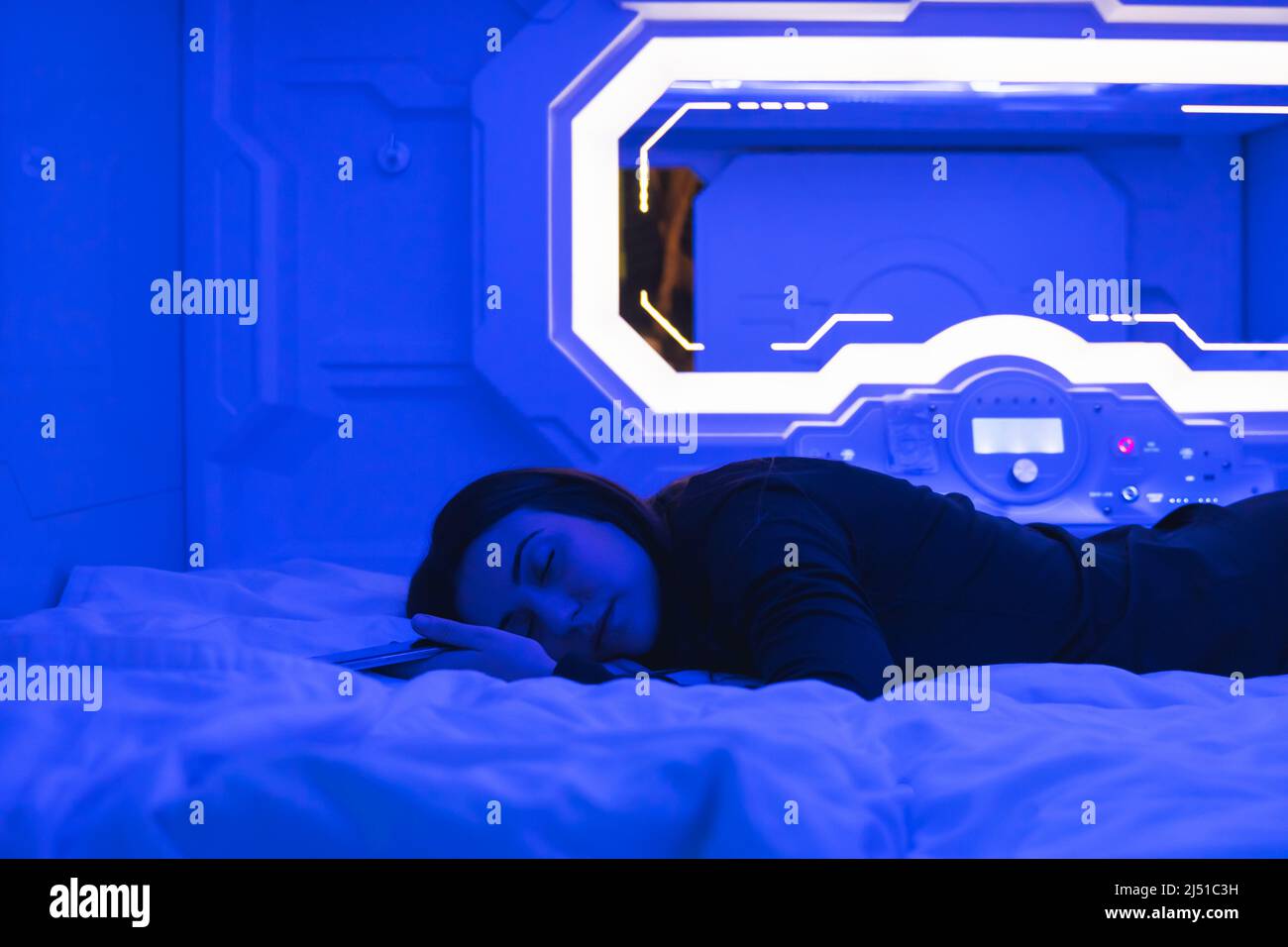 woman sleeping in the bedroom capsule. Stock Photo