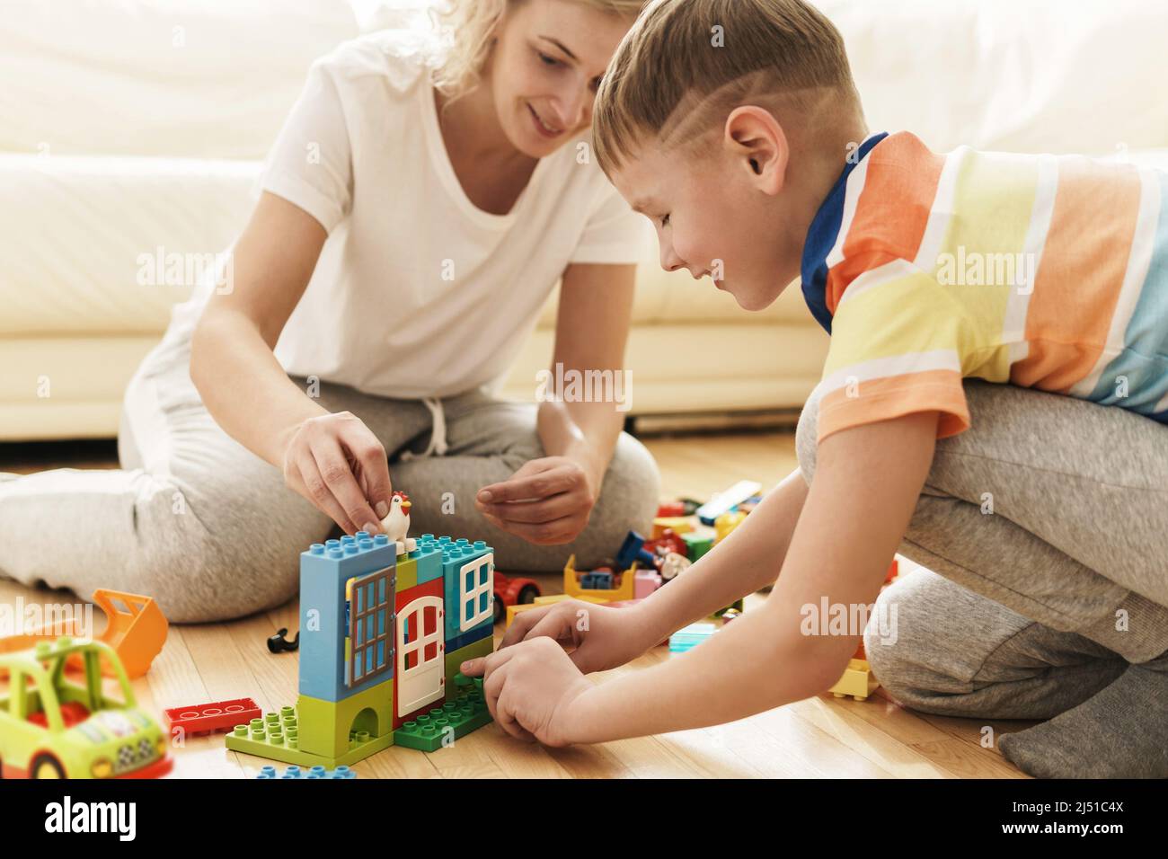 Cute boy and his happy mother playing together at home Stock Photo - Alamy