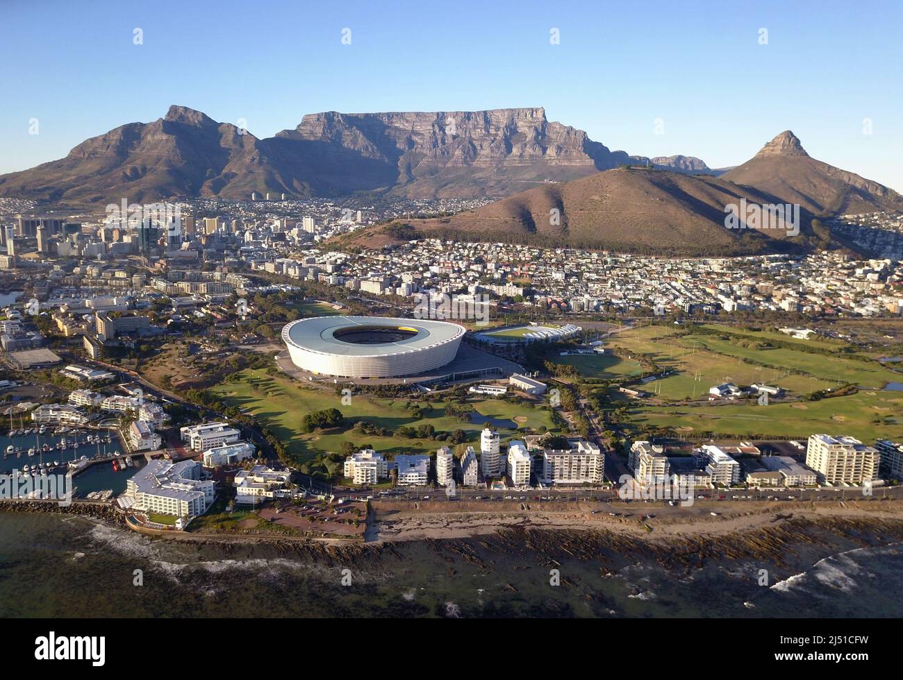 Cape Town, South Africa - 19 April 2022: Aerial view over Cape Town, with Cape Town stadium and Table Mountain . Stock Photo