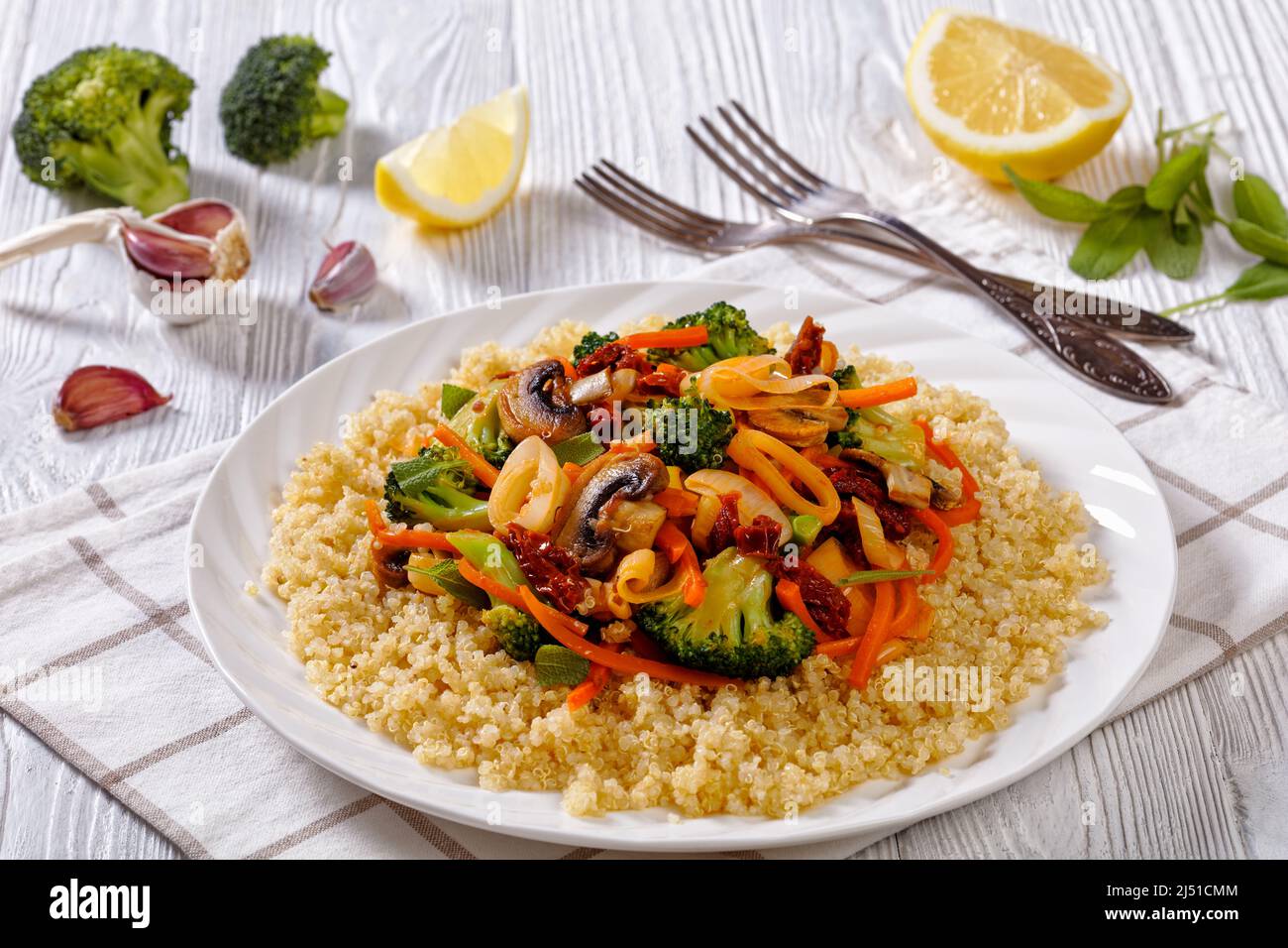 quinoa topped with stir fried broccoli, julienne carrots, sun dried