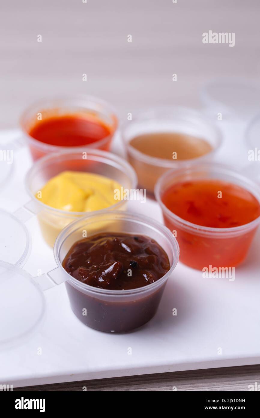 saucers with different types of sauce on a white background Stock Photo