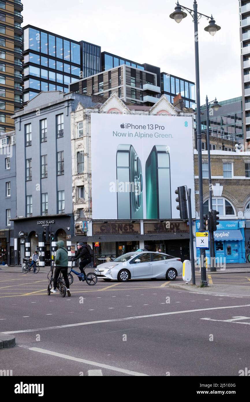 Apple Green iPhone 13 Pro advert billboard Commercial Street corner with Norton Folgate traffic intersection in Shoreditch London E2 UK  KATHY DEWITT Stock Photo
