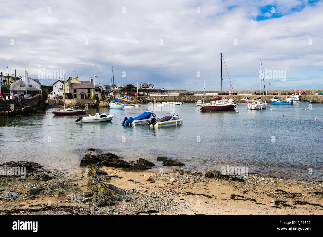 Boats moored in Cemaes harbour at high tide on the north coast. Cemaes Bay, Cemaes, Isle of Anglesey, north Wales, UK, Britain Stock Photo